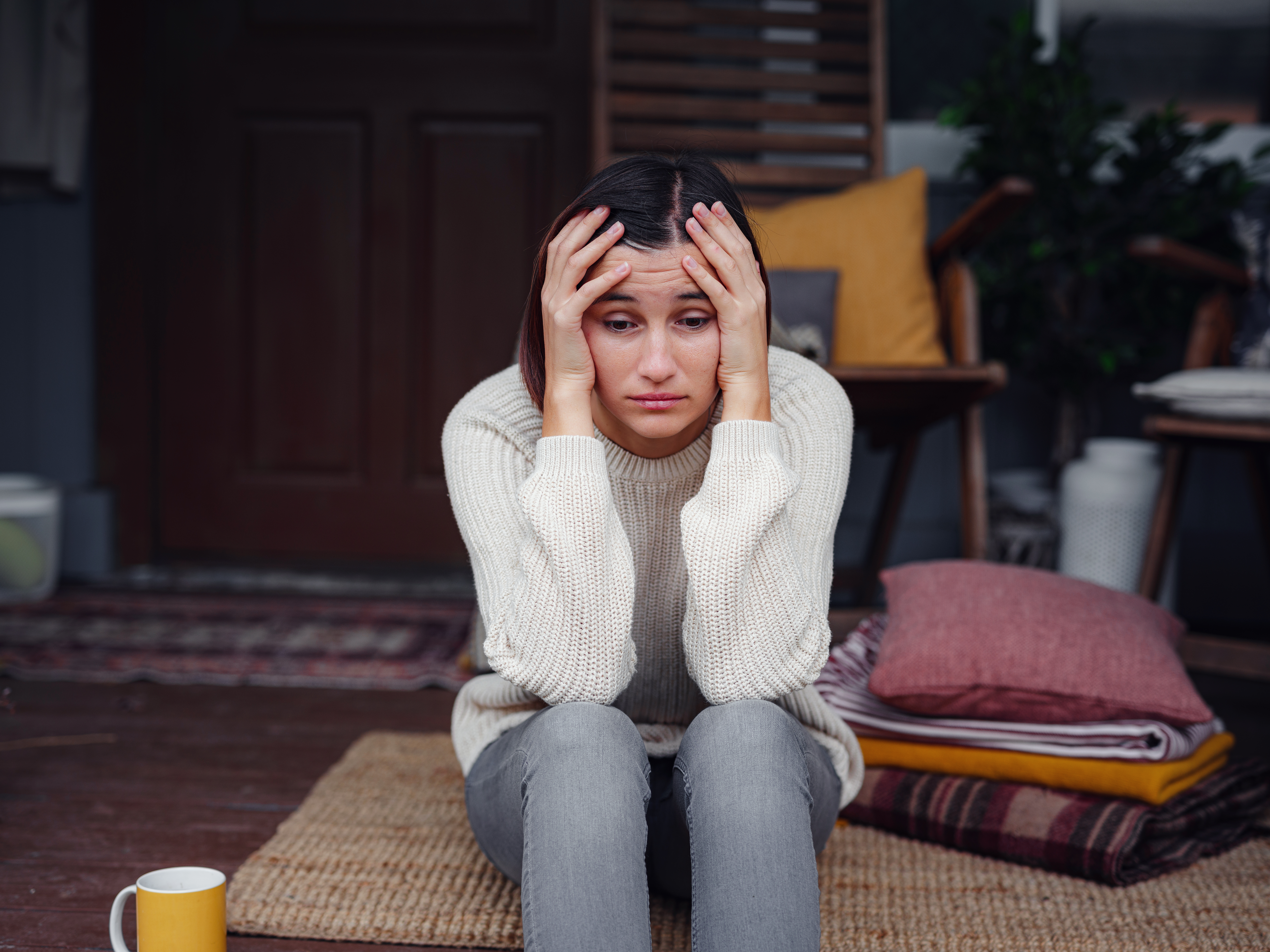 Young depressed asian woman sitting on porch of backyard. She feeling sad and worried suffering depression in mental health. Mental health, anxiety depressed thinking chinese lady.